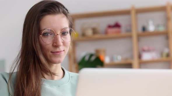 Businesswoman Using Laptop and Laughing While Sitting at Desk in Apartment Interior Spbi