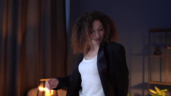 Cheerful Young Woman Celebrates Victory While Working at a Computer