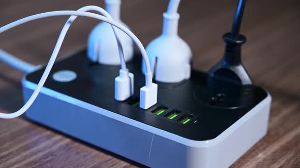 Closeup of a Male Hand Unplugging Cables From the Power Outlet