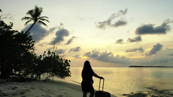 Lady tans on beautiful seashore beach journey by blue sea with white sand background of the Maldives