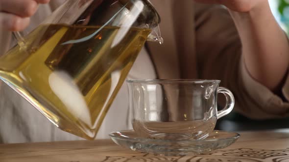 Girl Pours Hot Green Tea