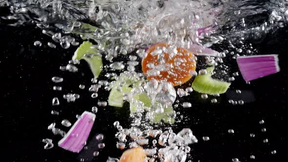 Fresh vegetables falling under boiling water 