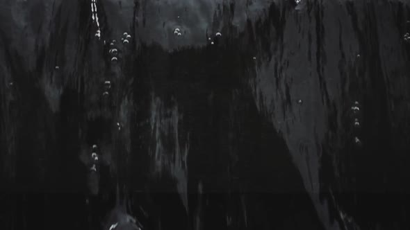 Falling and splashing water on black background
