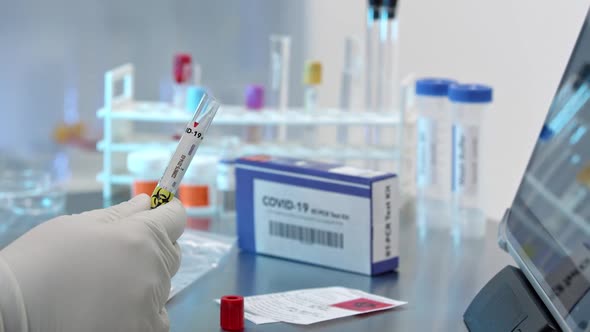 Technician adding covid-19 swab into test tub and sealing it up