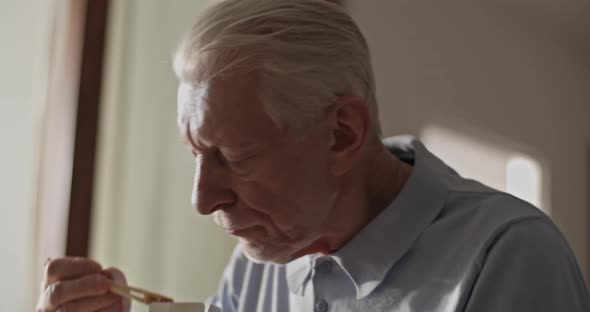 Elderly Man Eating Delivery Food