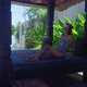 Cute Asian Girl In Swimming Suit Sitting Alone In Resort On Sunny Day SlowMotion - VideoHive Item for Sale