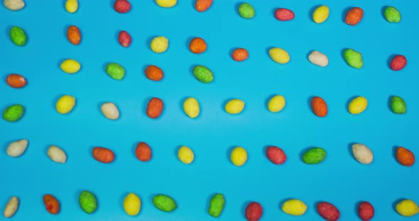 Stop Motion Animation Of Colored Sweets On A Blue Background, Top View.