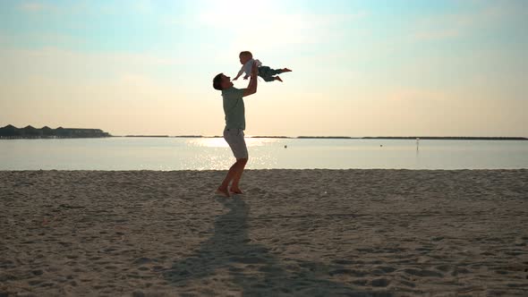 The Father Tosses His Son By the Handles and Then Catches Him