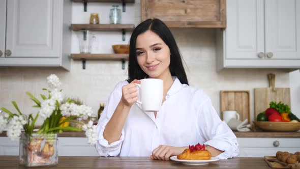 Good Morning Concept. Portrait Of Young Woman Smiling With Cup Of Coffee In Kitchen