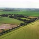 Drone Footage Flying Over Patchwork English Fields and Electric Pylons - VideoHive Item for Sale