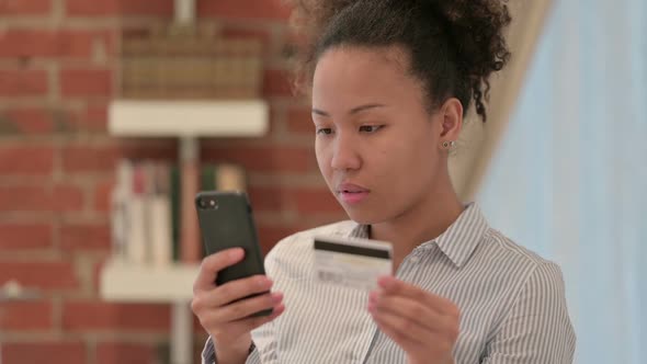 Portrait of African American Woman Making Online Payment on Smartphone