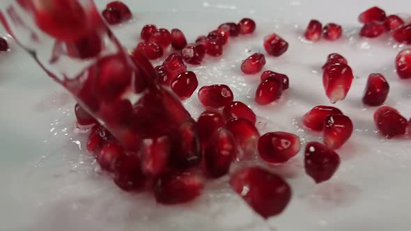 Water with Pomegranate Grains Is Flowing Down