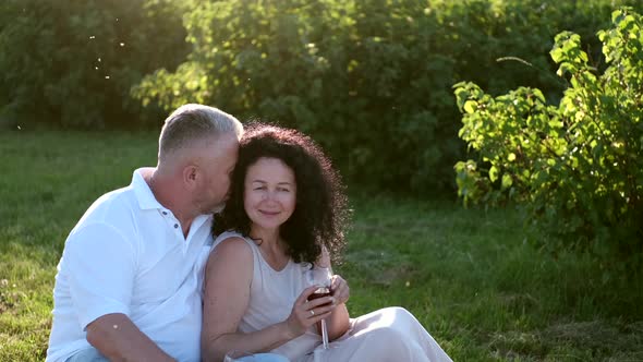 Mature Couple on a Picnic Date in the Garder