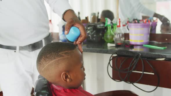 African man making finishes at African boy hair