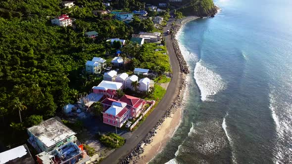 Aerial pull back of local homes on British Virgin Island Tortola on the beach.