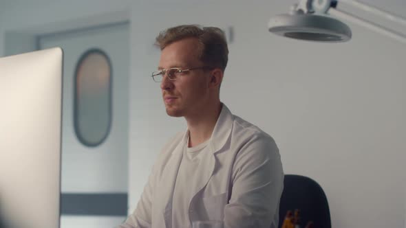 Portrait Doctor Working Computer in Modern Clinic