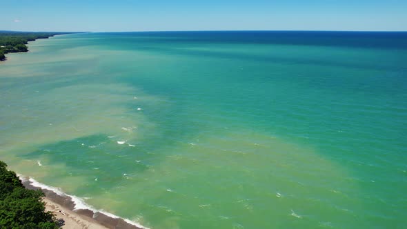 Spectacular Aerial drone video footage of beautiful Lake Erie during summer on a sunny day