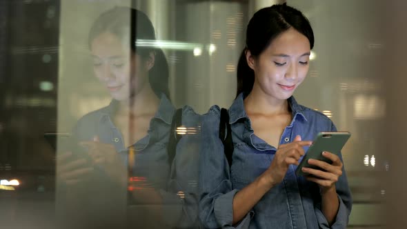 Young woman working on mobile phone at night 