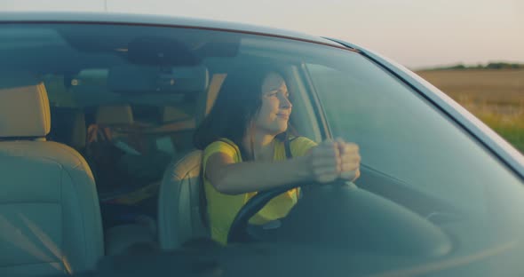 Young Upset Girl in Broken Car on Side of Road