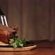 Cut Off a Large Piece of Meat From the Pork Knuckle with a Knife. Ready Meat Dish with Garnish in a - VideoHive Item for Sale