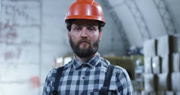 Worker Smiling Into Camera in a Warehouse