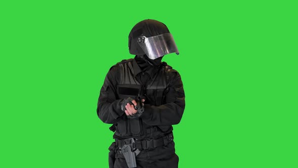 Anti Terrorist or Riot Unit Walking and Aiming with a Pistol on a Green Screen Chroma Key