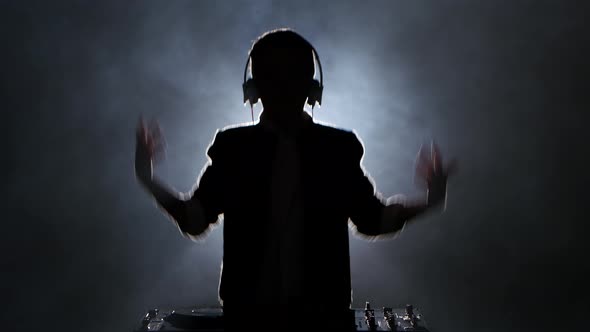 Silhouette Boy Dj Jumps, Dance and Plays Music, Smoky Background