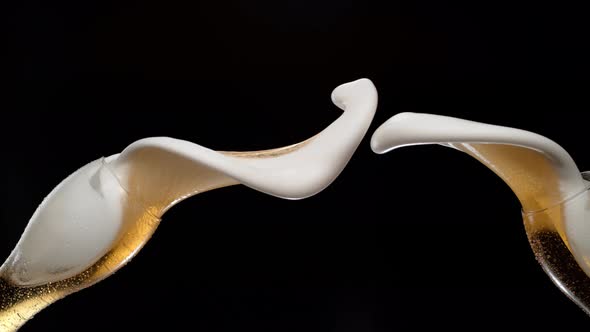 Beer spilled out of glasses and making splash. Slow Motion. alt