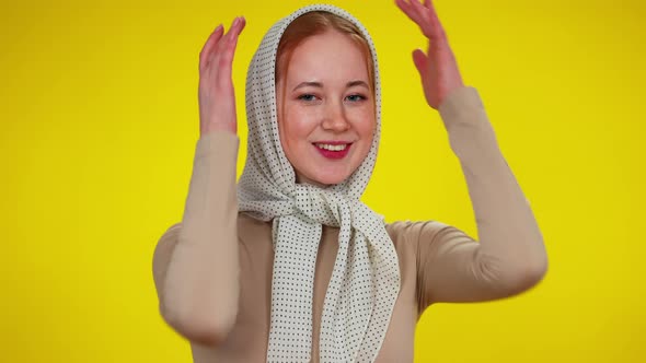 Portrait of Young Slim Redhead Woman in Kerchief Posing at Yellow Background