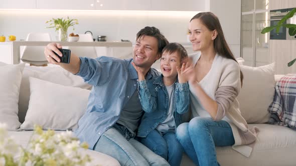 Family Takes Selfie on the Sofa