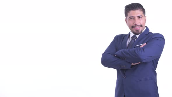 Profile View of Happy Bearded Persian Businessman Smiling with Arms Crossed