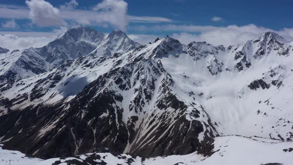 Flight above snowcapped mountains near Elbrus