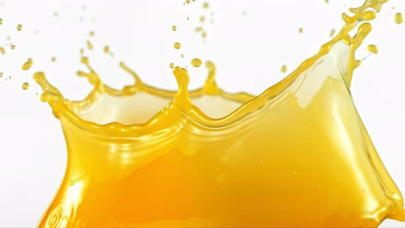 Super Slow Motion Shot of Orange Juice Splash Isolated on White Background at 1000Fps