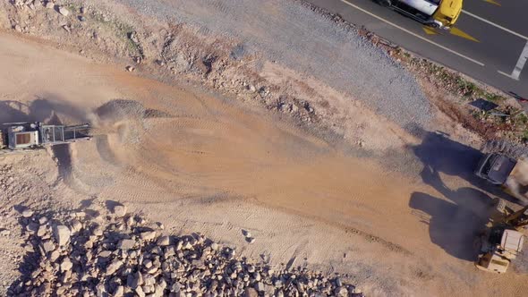 Fast Motion of Heavy Machinery Working at Construction Site Near the Asphalt Road