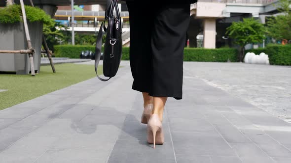 Business Woman Legs In High-Heeled Shoes Walking With Briefcase