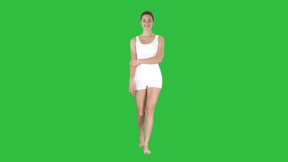 Siling happy charming fitness girl walking on a Green Screen