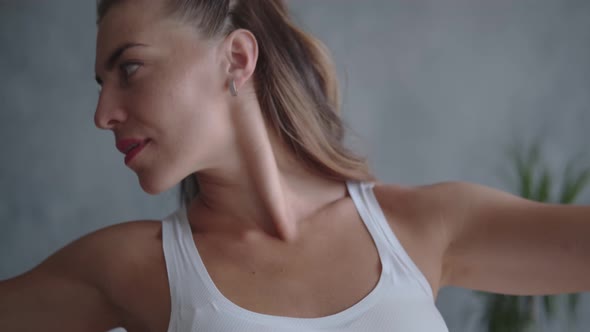 Portrait of a Female Athlete Warms Up Shoulder Before Training