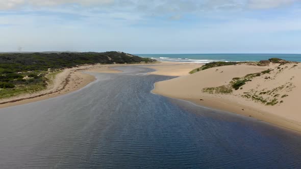 Aerial shot of an estuary on the coast.