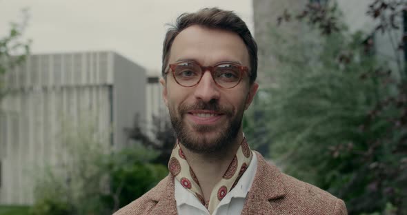 Close Up View of Handsome Man with Beard Looking and Smiling To Camera. Portrait of Stylish Guy