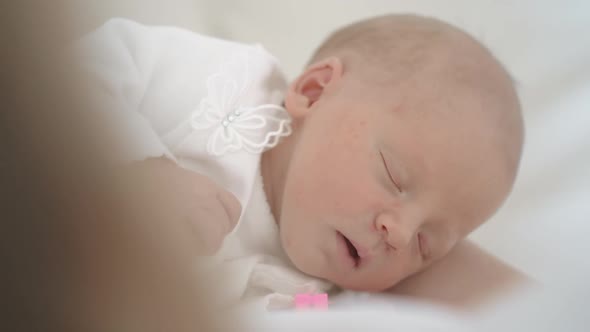 Newborn Baby Girl Asleep While in Her Crib