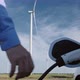 Man inserts charging plug and charges white electromobile. - VideoHive Item for Sale