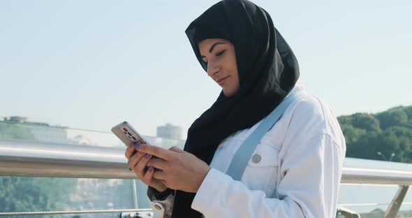 Modern Muslim Woman Using Smartphone