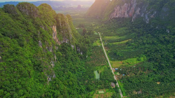 An aerial view from a drone flying over a beautiful mountain view road