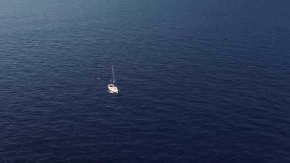 Aerial View on White Sailing Yacht Floating Across Mediterranean Sea. Lipari Islands. Sicily, Italy