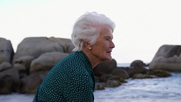 Woman sitting on the beach 4k