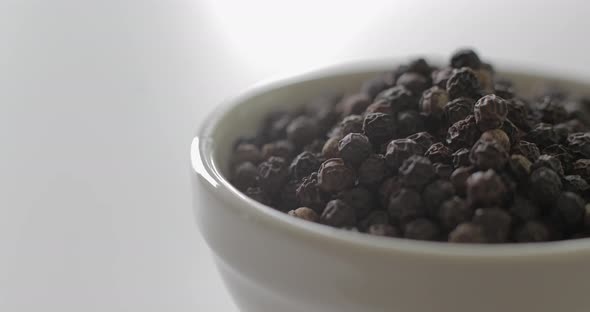 Detail of Peppercorns in a white bowl