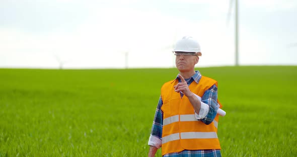 Male Engineer Working While Holding Blueprint