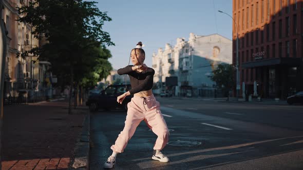 Stylish Dancer Performs Vogue Moves on Road at Buildings