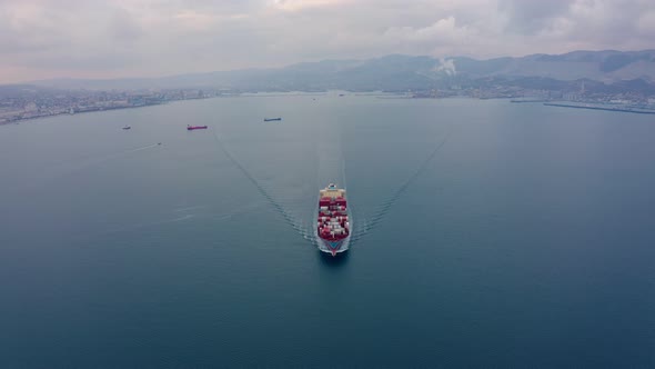 Aerial View of a Container Ship Sailing the Ocean on a Warm Summer Evening