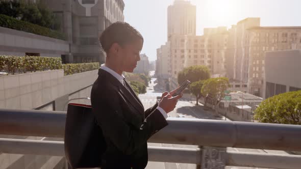 Mixed ethnicity business woman works on her phone